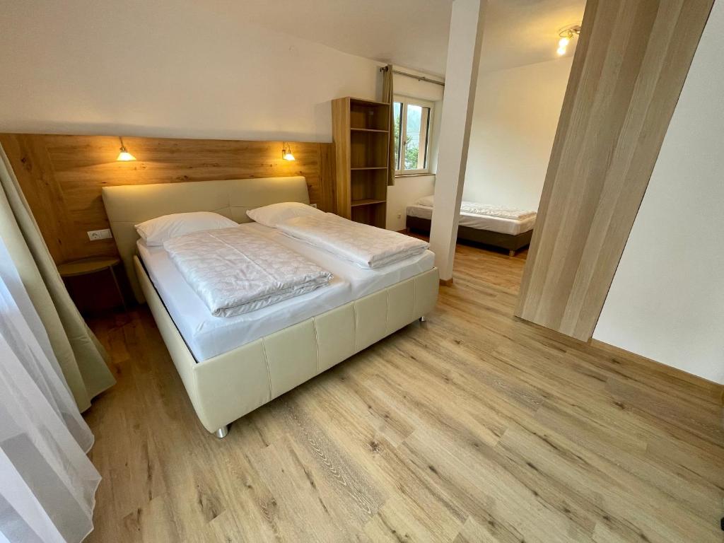a bedroom with a large bed in a room at Garni Transit B&B - Your Stopover in Vipiteno