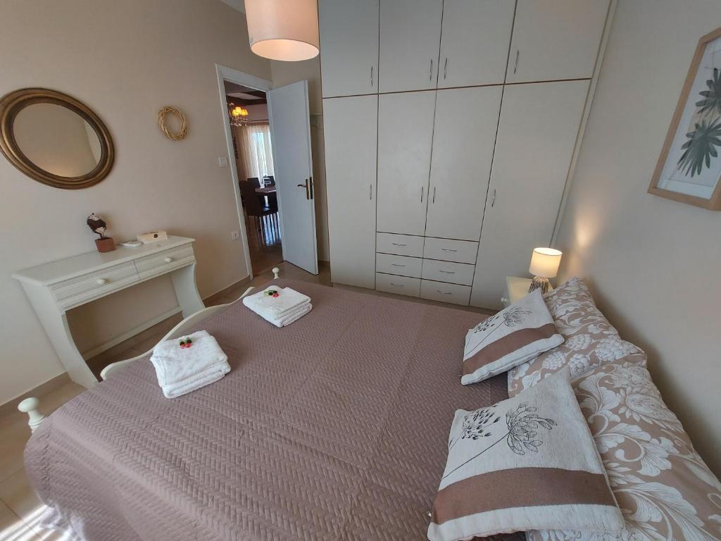 a bedroom with a bed with two towels on it at Meliti Villa in Argostoli