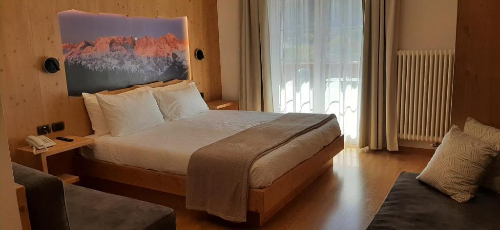 Postel nebo postele na pokoji v ubytování Hotel Garni Arnica