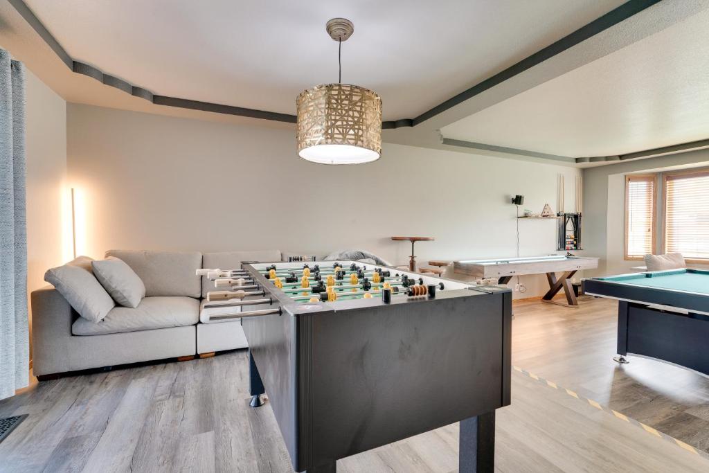 a living room with a couch and a pool table at Moses Lake Vacation Rental with Hot Tub and Game Room in Moses Lake