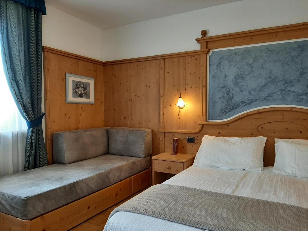 Postel nebo postele na pokoji v ubytování Hotel Garni Arnica