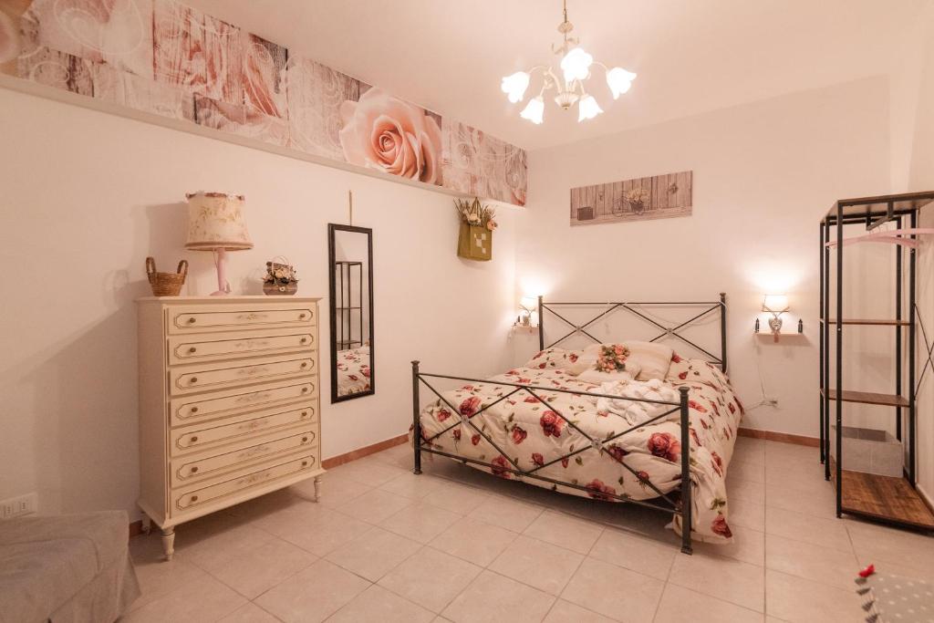 a bedroom with a bed and a dresser at il vicolo delle scuole pie in Città della Pieve
