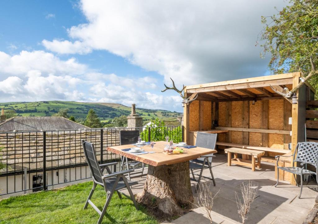 a patio with a wooden table and chairs at 3 Ivy Terrace in Bradley