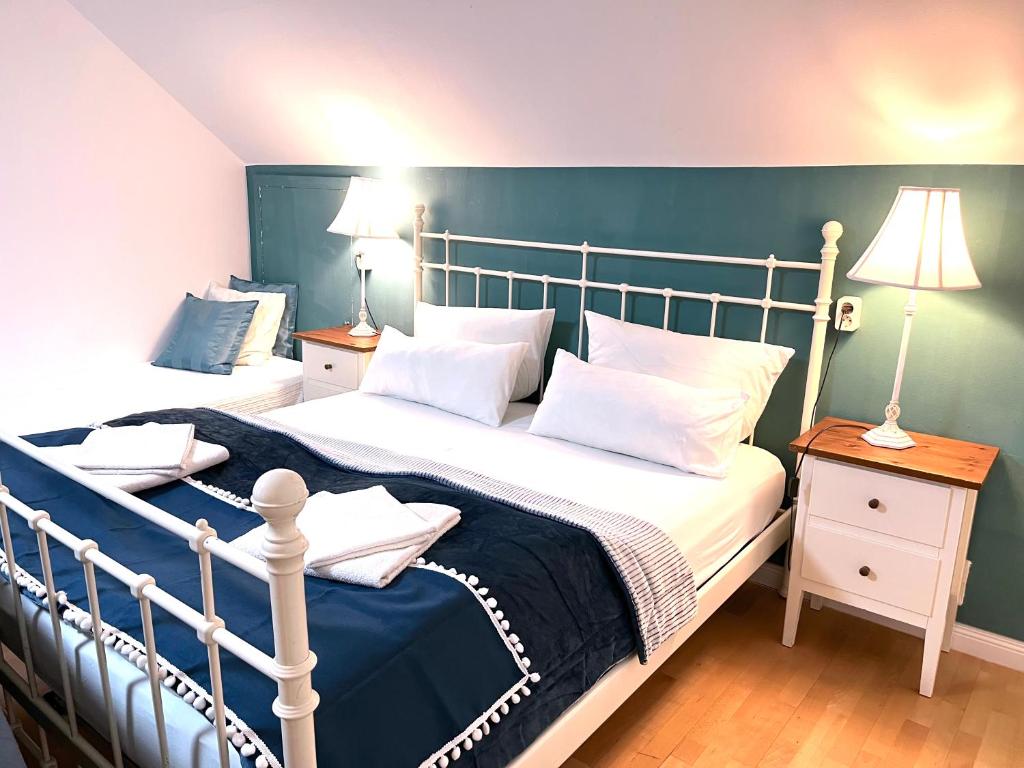 a bedroom with a large bed with a blue headboard at VILLA ORCHARD Frankfurt in Zeilsheim
