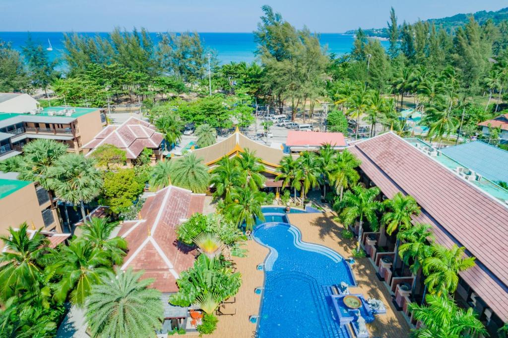 eine Luftaufnahme eines Resorts mit Swimmingpool in der Unterkunft Princess Kamala Beachfront Hotel - SHA Extra Plus in Kamala Beach
