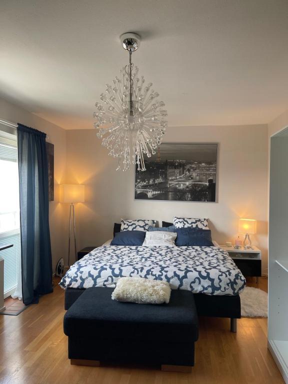 a bedroom with a bed and a chandelier at Twayi Luxury Suites in Jönköping