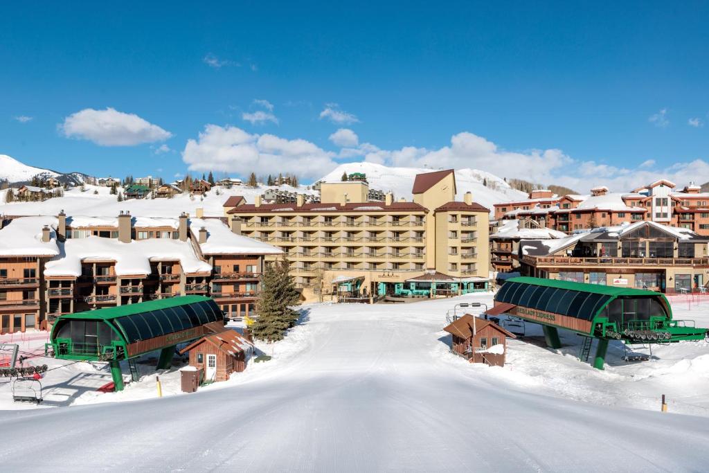 a resort in the snow with snow covered buildings at Elevation Hotel & Spa in Mount Crested Butte