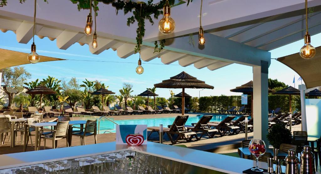 a resort with a pool and chairs and a bar at Lagos Atlantic Hotel in Lagos