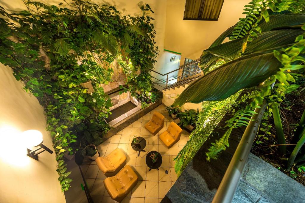 an overhead view of a room with chairs and plants at Casa Fanning Hotel in Lima