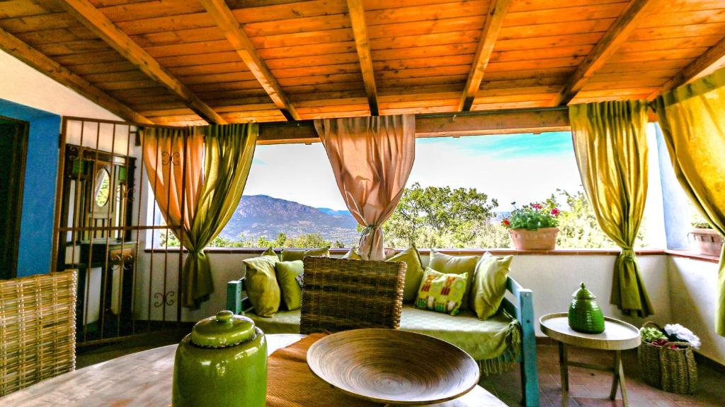 a room with a couch and a table and a window at Casa Vacanze Giada in Oliena
