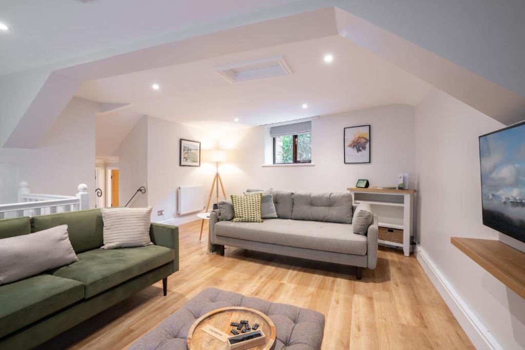 a living room with two couches and a tv at Spacious Property with Waterfall View by LetMeStay in Ambleside