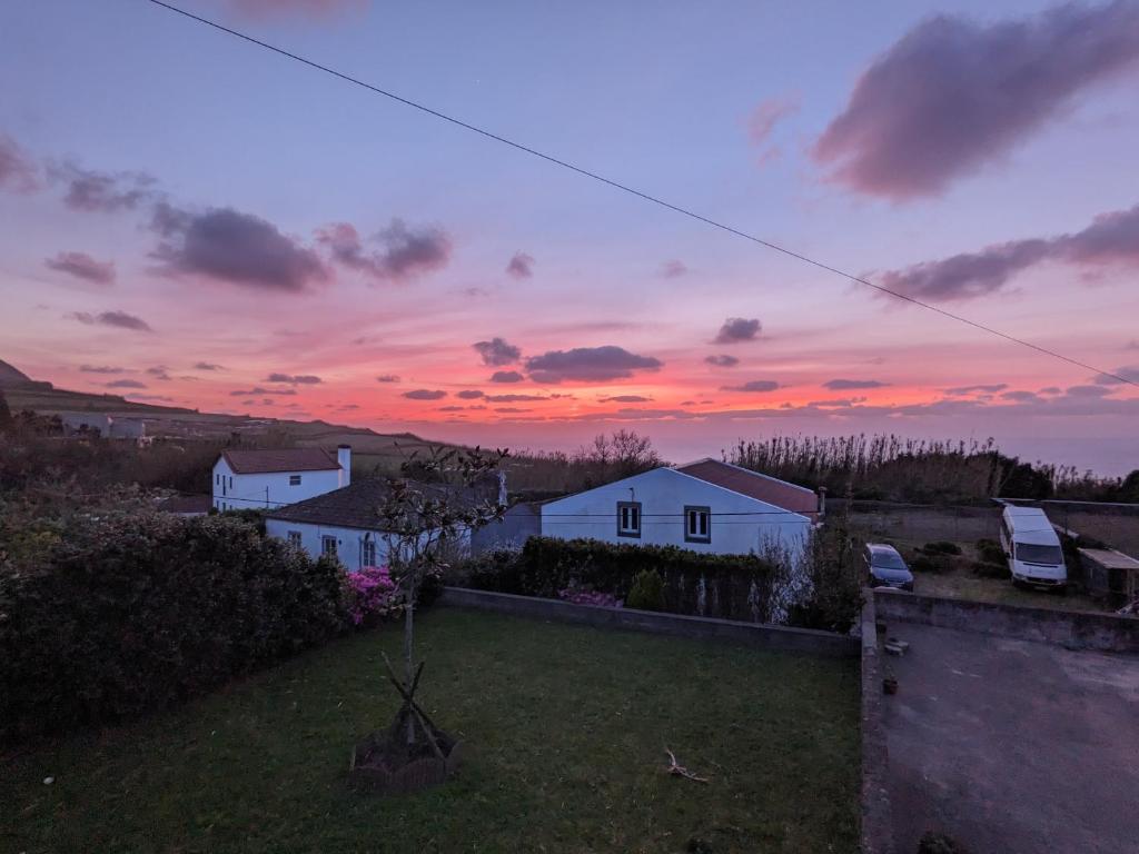 a view of a house with a sunset in the background at Casa Pavão in Pilar