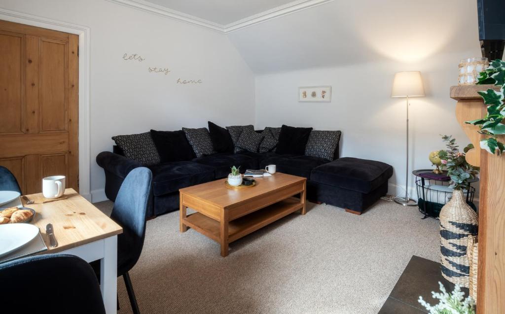 a living room with a couch and a coffee table at Taigh Carnan - 2 Huntly Terrace in Inverness