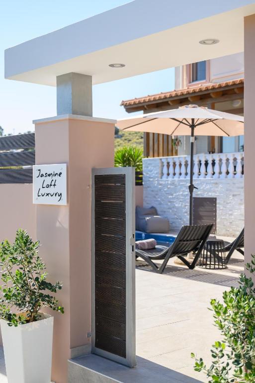 a door in a house with a sign on it at Jasmine loft luxury 1 in Kokkini Khanion