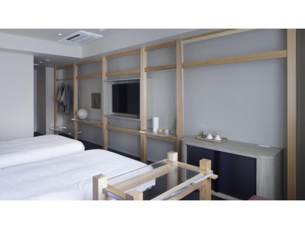 a hotel room with two beds and a television at SOKI KANAZAWA - Vacation STAY 40333v in Kanazawa