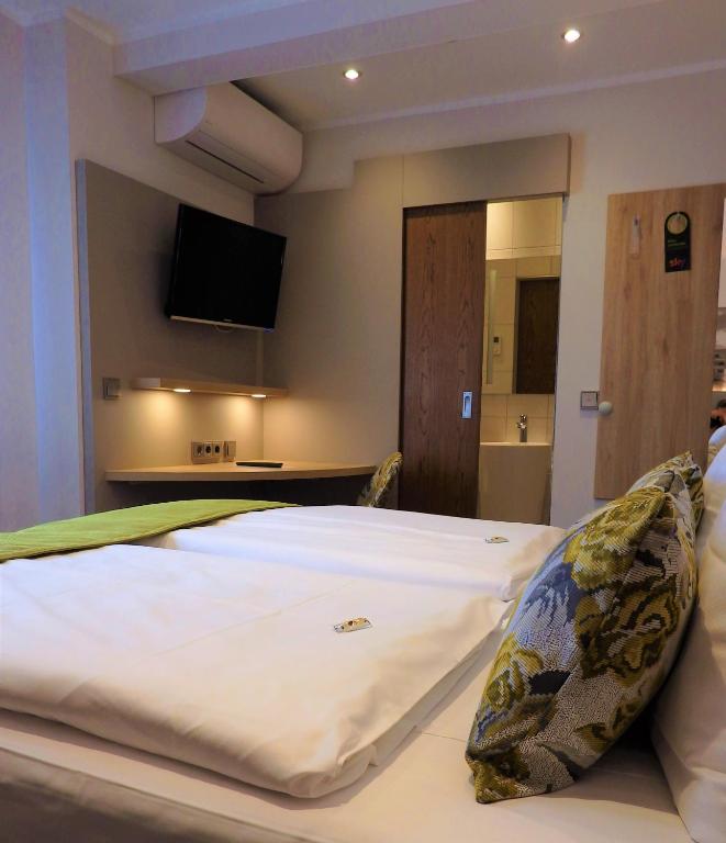Postel nebo postele na pokoji v ubytování Hotel Rose