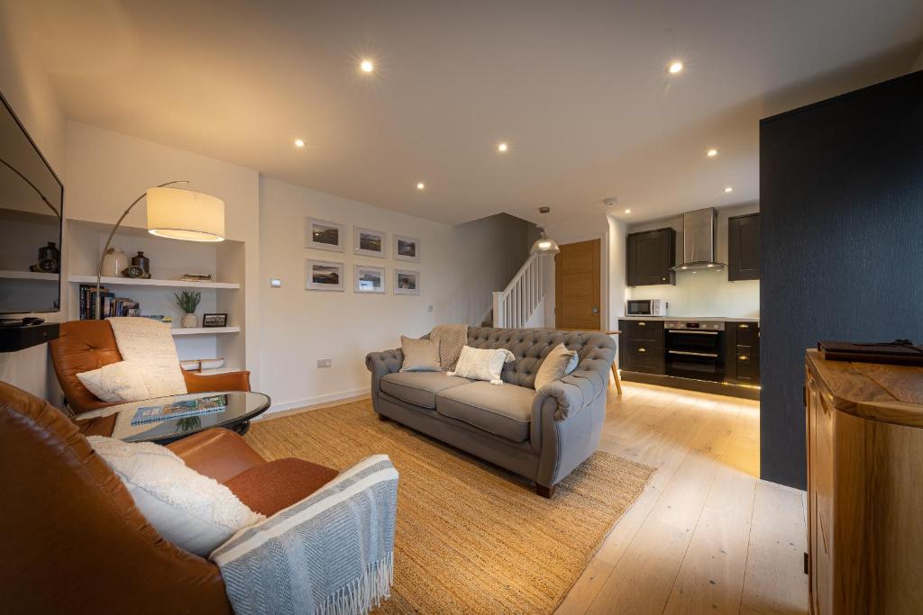 a living room with a couch and a table at Tidal Cottage in Ardvasar