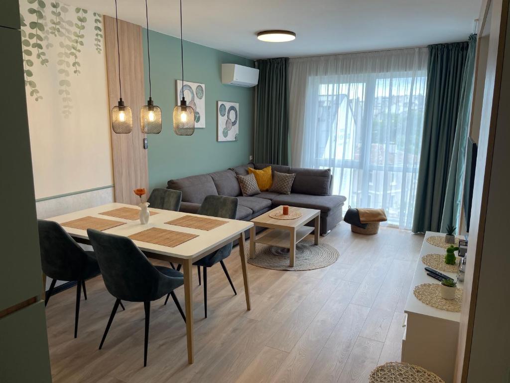 a living room with a table and a couch at Dream_Apartment in Varna City