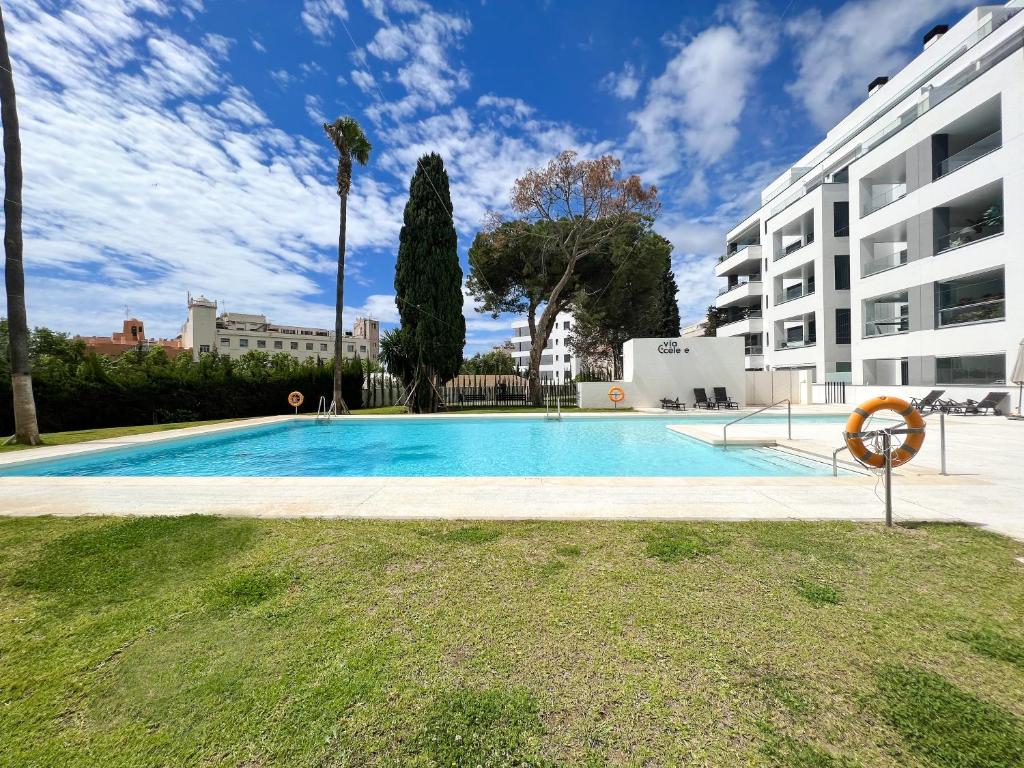 a swimming pool in front of a building at Apartment in Marbella Center with private parking in Marbella