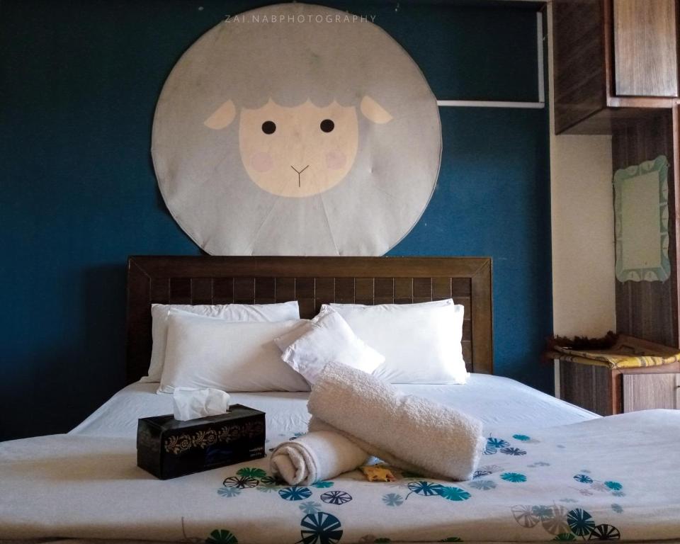 a bedroom with a bed with a clock on the wall at Republika by Summit Resorts in Abbottabad