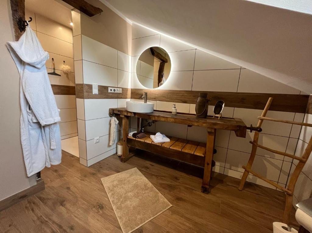 a bathroom with a sink and a mirror at Lochhof Zwei - Eifelurlaub mit Farmcharme in Hellenthal