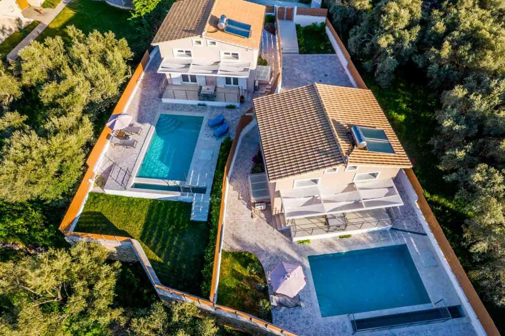 an overhead view of a house with two swimming pools at Elianthos Luxury Villas in Tsoukaladhes