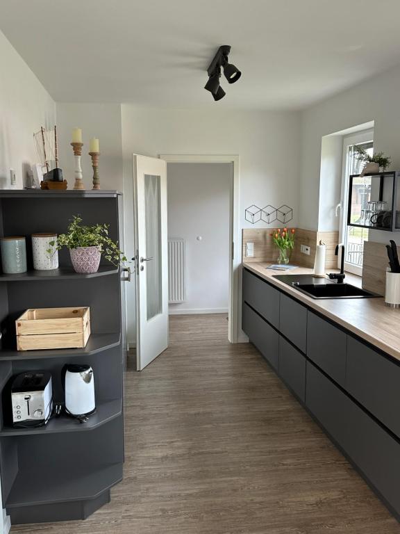 a kitchen with black and white cabinets and a sink at Kühlhaus Hagenburg in Hagenburg