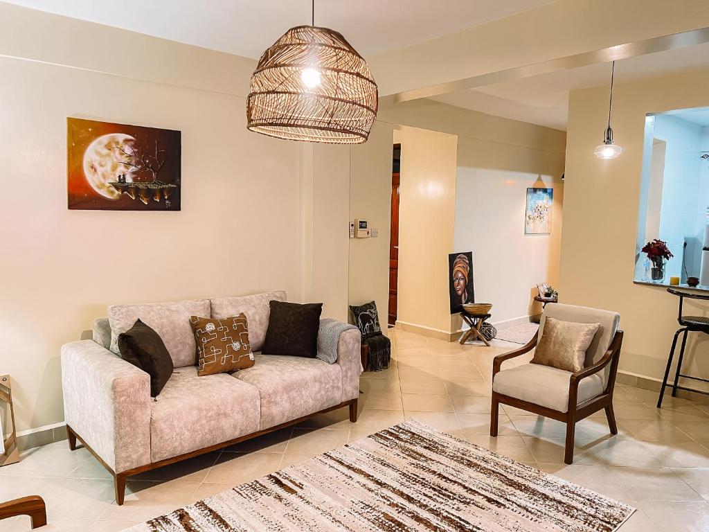 a living room with a couch and a chair at Comfort Oasis in Dar es Salaam