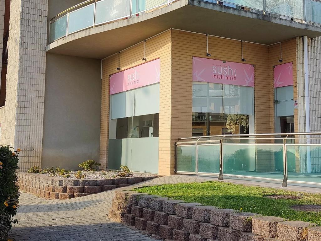 a building with a sign that reads sushi warehouse at The Surf Studio - Ericeira in Ericeira