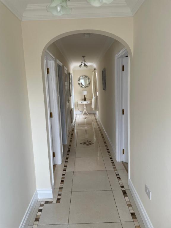 an empty hallway with white walls and a tile floor at Hillside House- Pine View in Ballinamuck