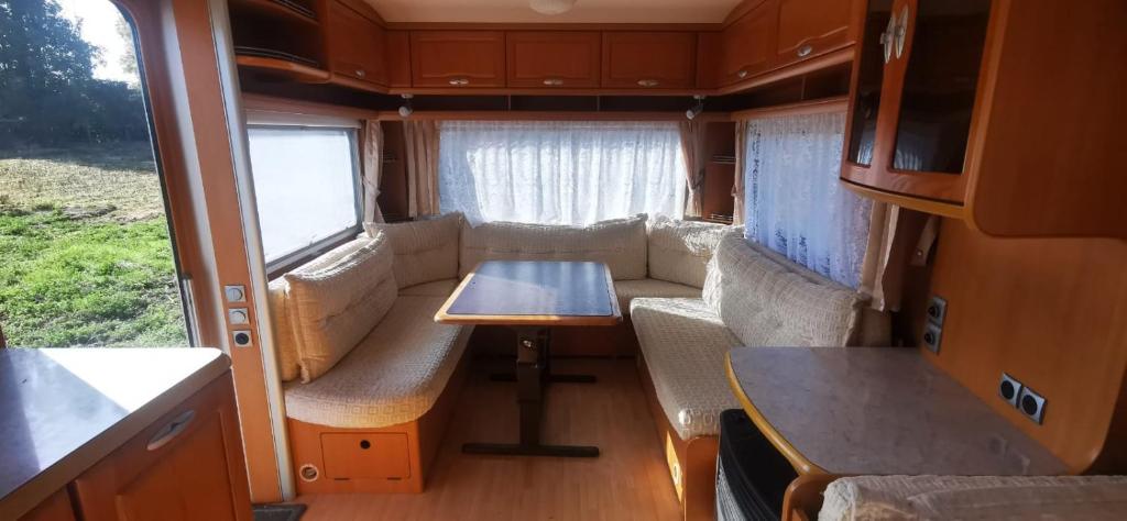 a living room in an rv with a table and chairs at ALOJAMIENTO SAN FELIPE in Santa María