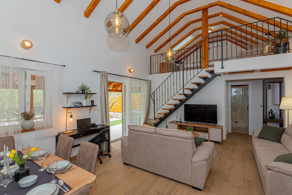 a living room with a couch and a table at Holiday Home Parona in Šibenik