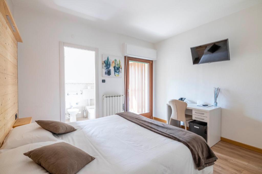 Postel nebo postele na pokoji v ubytování B&B Castello Cimbergo