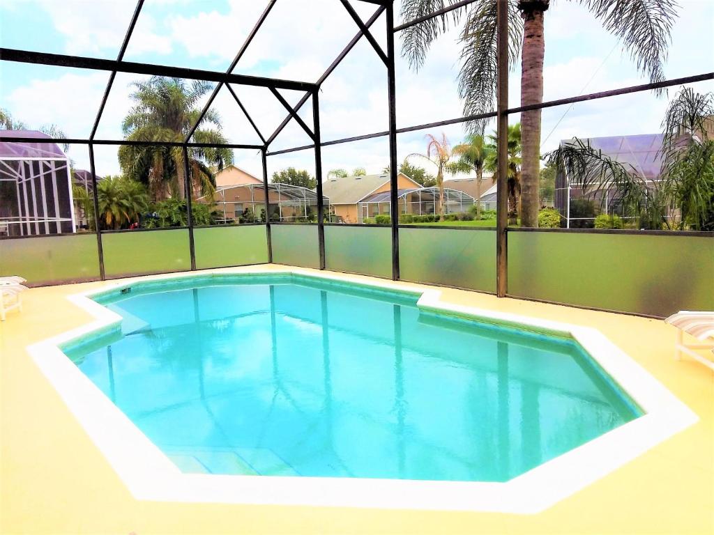 a swimming pool in the middle of a house at 6 bedrooms pool home 10 min from Disney in Orlando