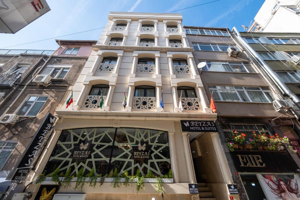 a tall white building with flowers in front of it at Beyzas Hotels & Suites in Istanbul