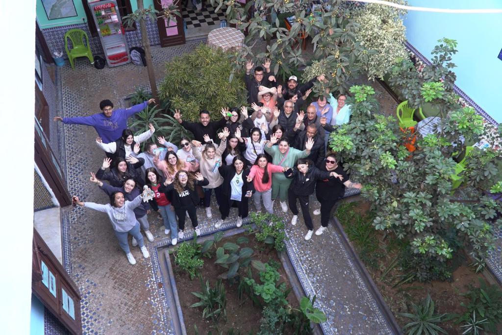 a group of people posing for a picture in a garden at Auberge De Jeunesse in Rabat