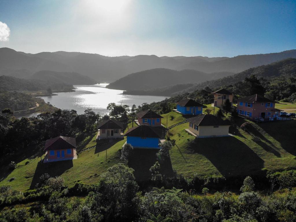 a group of houses on a hill with a lake at Villas da Bocaina in Bananal