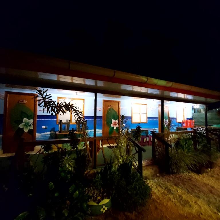 a building with paintings on the side of it at night at Moorea Vaiare Lodge in Moorea
