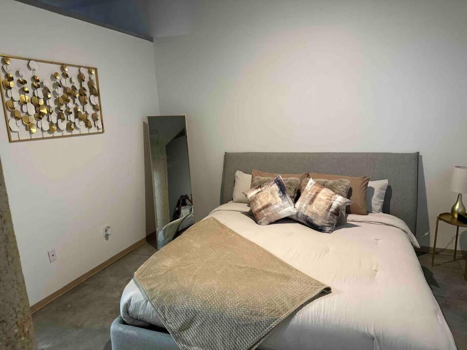 a bedroom with a large bed with pillows on it at Luxury Cozy Loft Downtown STL in Saint Louis