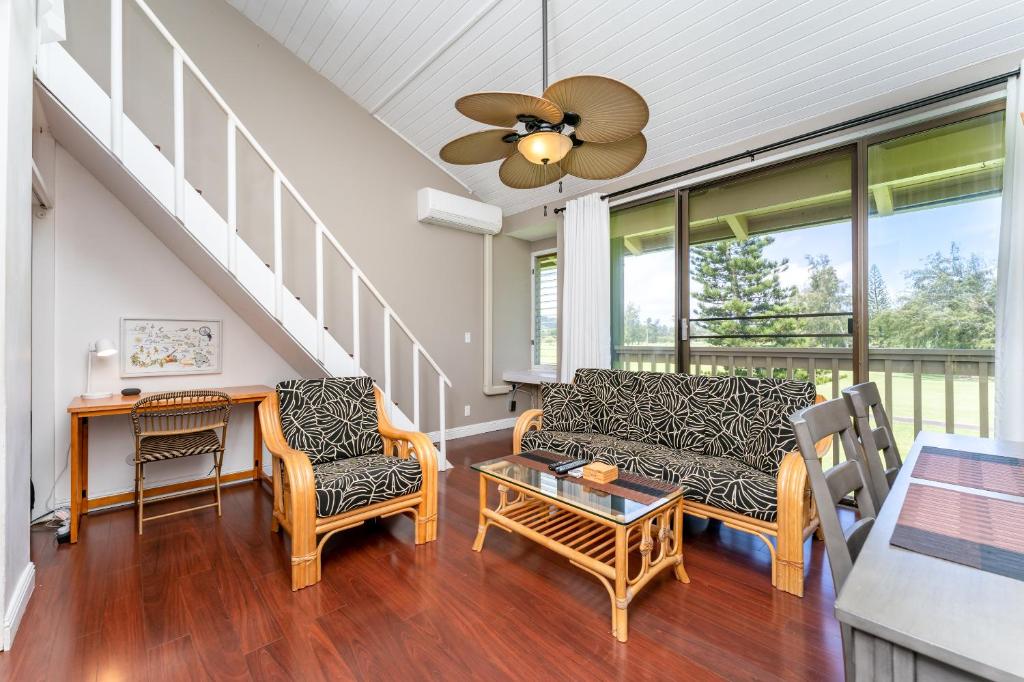 a living room with a couch and chairs and a table at Bamboo Hale - Golf Course View - Sleeps 2 in Kahuku