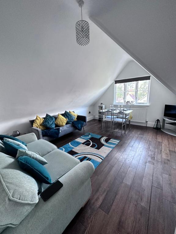 a living room with a couch and a table at Lancaster Heights in Woodhall Spa