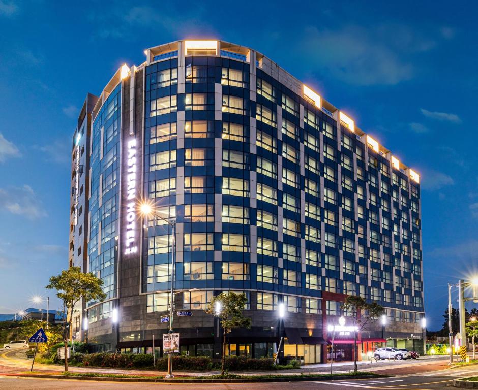 un edificio alto con luces en el costado. en Eastern Hotel Jeju, en Seogwipo