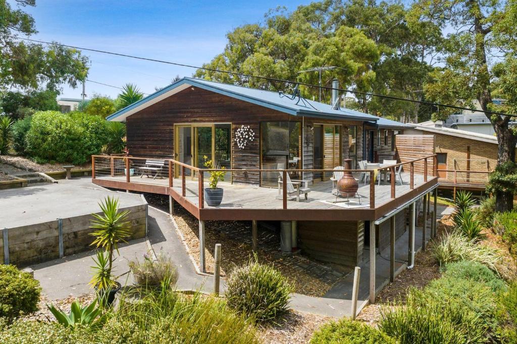 a wooden house with a deck and a patio at Otway Rest in Lorne