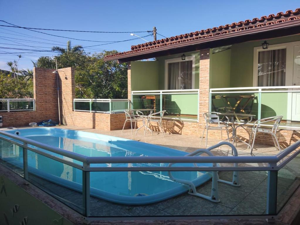 a swimming pool in front of a house at Sonho 2 Guest House in Búzios
