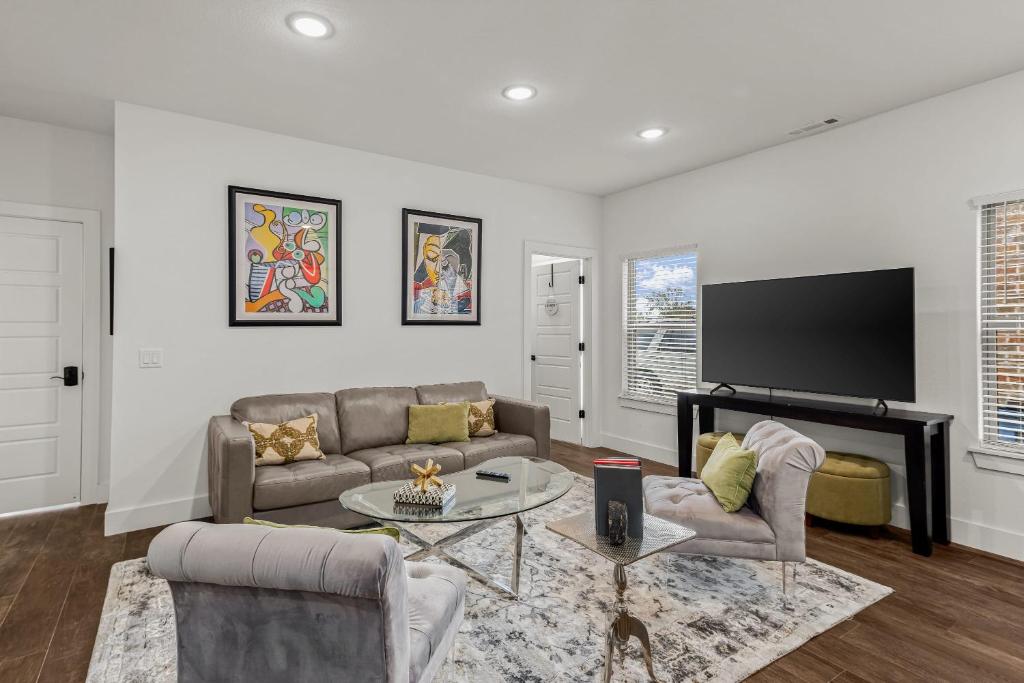 a living room with a couch and a tv at The Warhol - Pet-Friendly Apartment in Bentonville