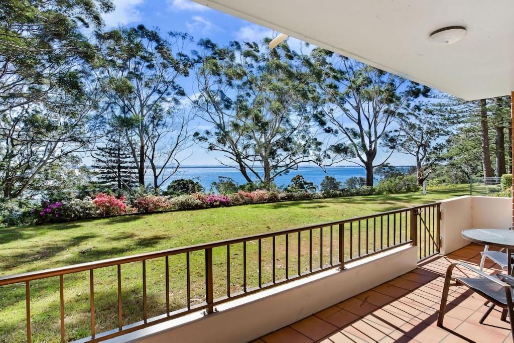 a balcony with a view of the ocean at Kamillaroi Walk to restaurants cafes and beach in Nelson Bay