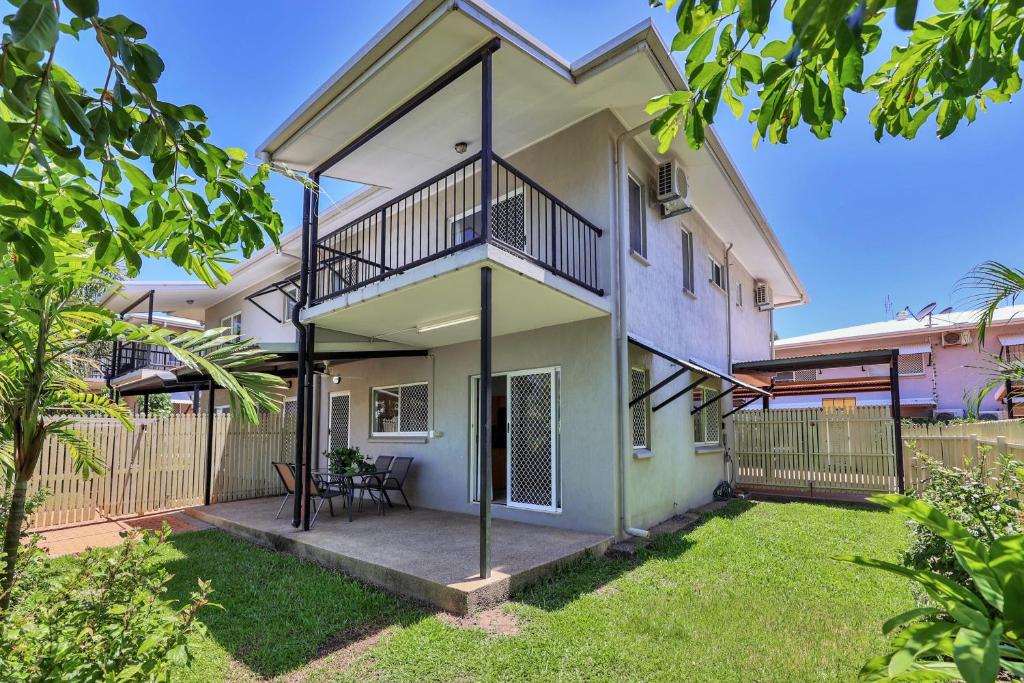 a house with a balcony and a yard at OFFLINE - Charming 3BR Retreat in Central Location of Darwin in Stuart Park