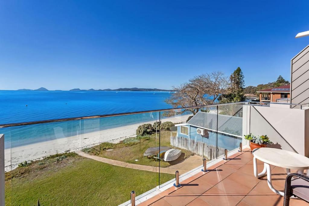 a view of the ocean from the balcony of a house at Gorgeous Harbourside with Stunning views in Soldiers Point