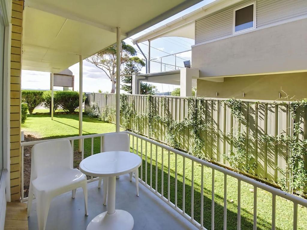 a balcony with a table and two chairs on it at Beachside Shoal Bay Unit 4 in Shoal Bay