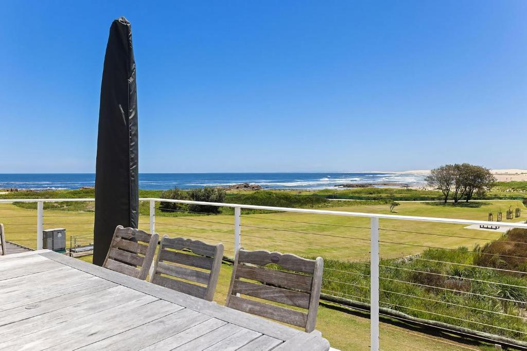 a wooden deck with a view of the ocean at Birubi Beach Waterfront in Anna Bay
